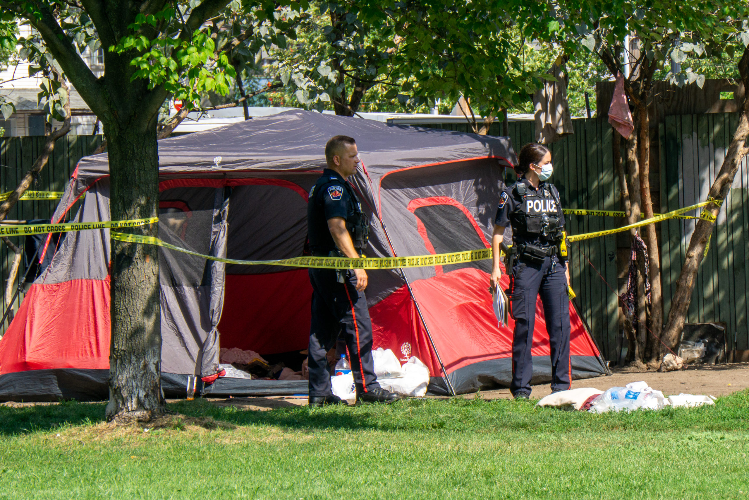 Police stand at an encampment
